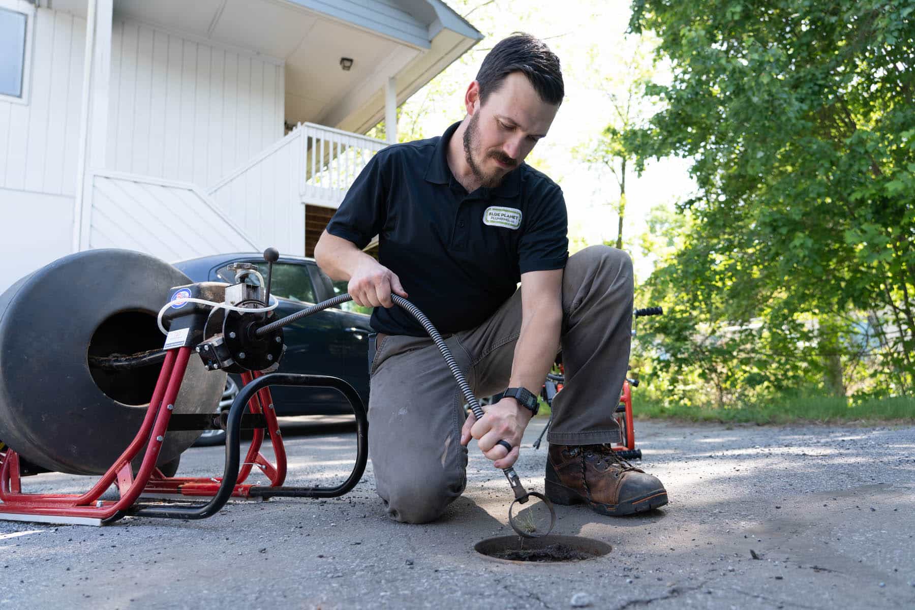 Rush technician clearing a clogged kitchen drain line
